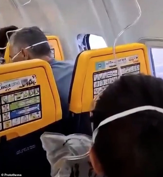 Wife saves husband dangling 20,000 feet by holding on as he falls out of plane window after cabin depressurization incident forces Ryanair flight passengers into emergency rescue operation over Eur...